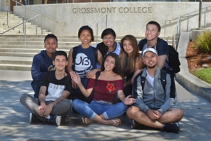 students seated in front of grossmont signage